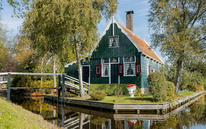 Traditional Dutch house by a canal in Zaanse Schans, Netherlands.