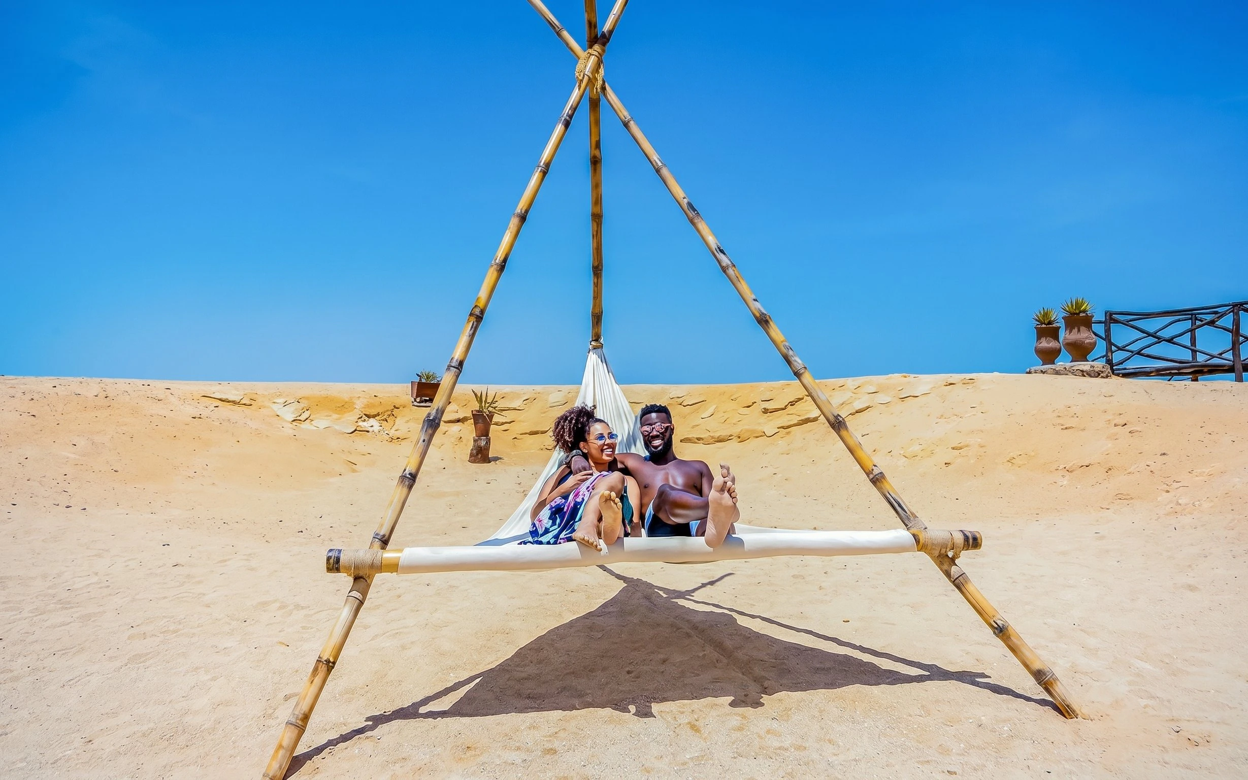 Couple relaxing on a hammock at Orange Bay, Giftun Island, Hurghada.
