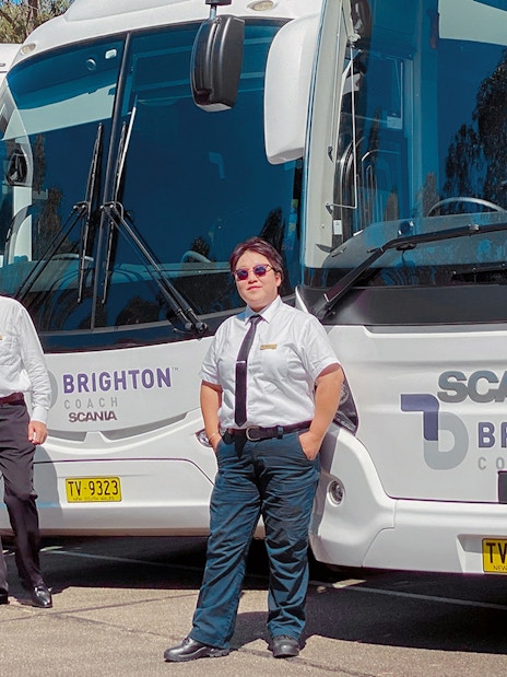 Tour guides standing in front of Brighton Coach buses for Sydney Night Tour.