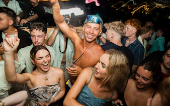 Partygoers enjoying a night boat party in Split with a live DJ and free shots.