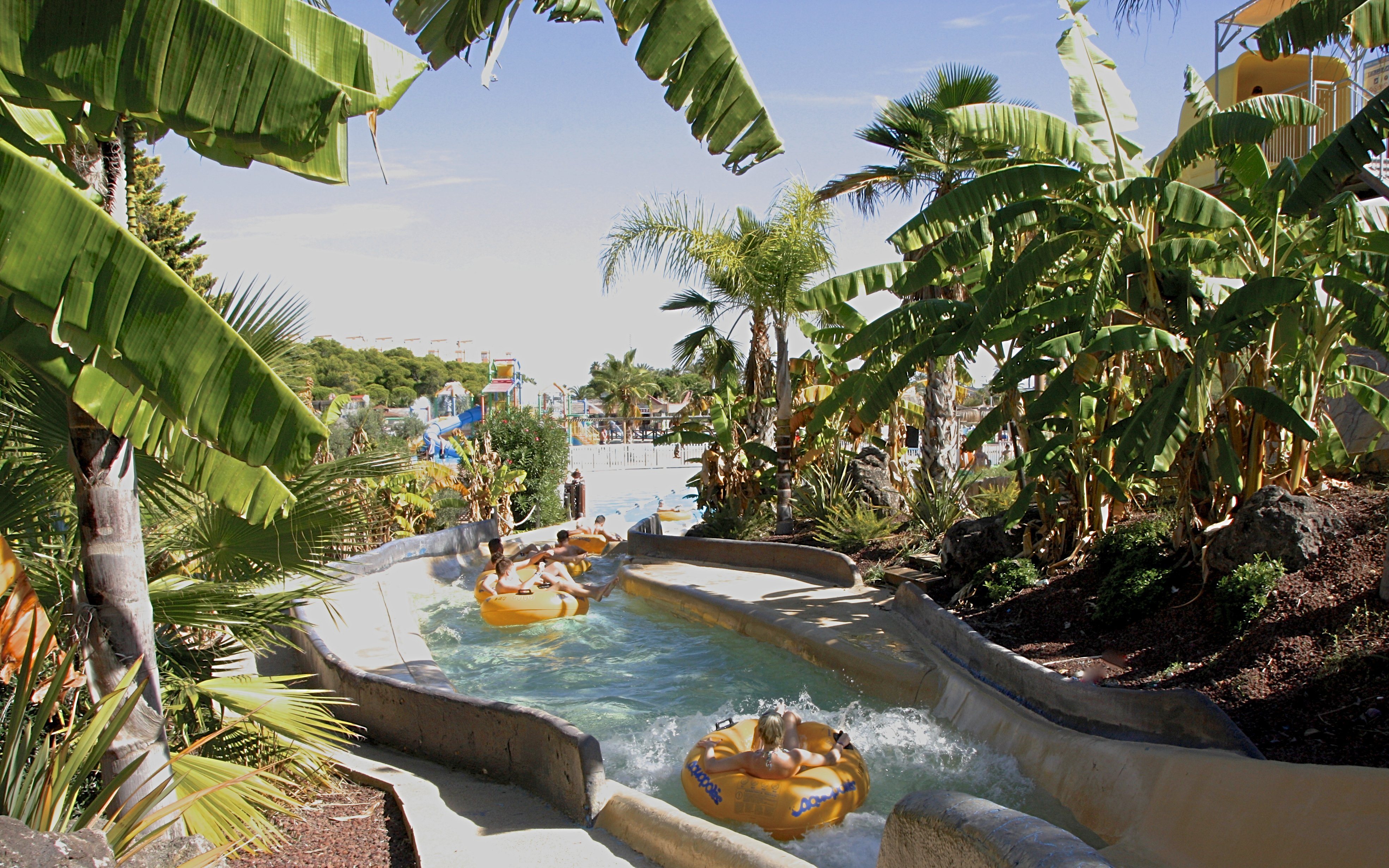 Visitors enjoying a lazy river ride at Aquopolis Costa Daurada, Tarragona water park.