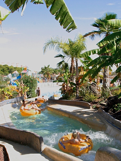 Visitors enjoying a lazy river ride at Aquopolis Costa Daurada, Tarragona water park.