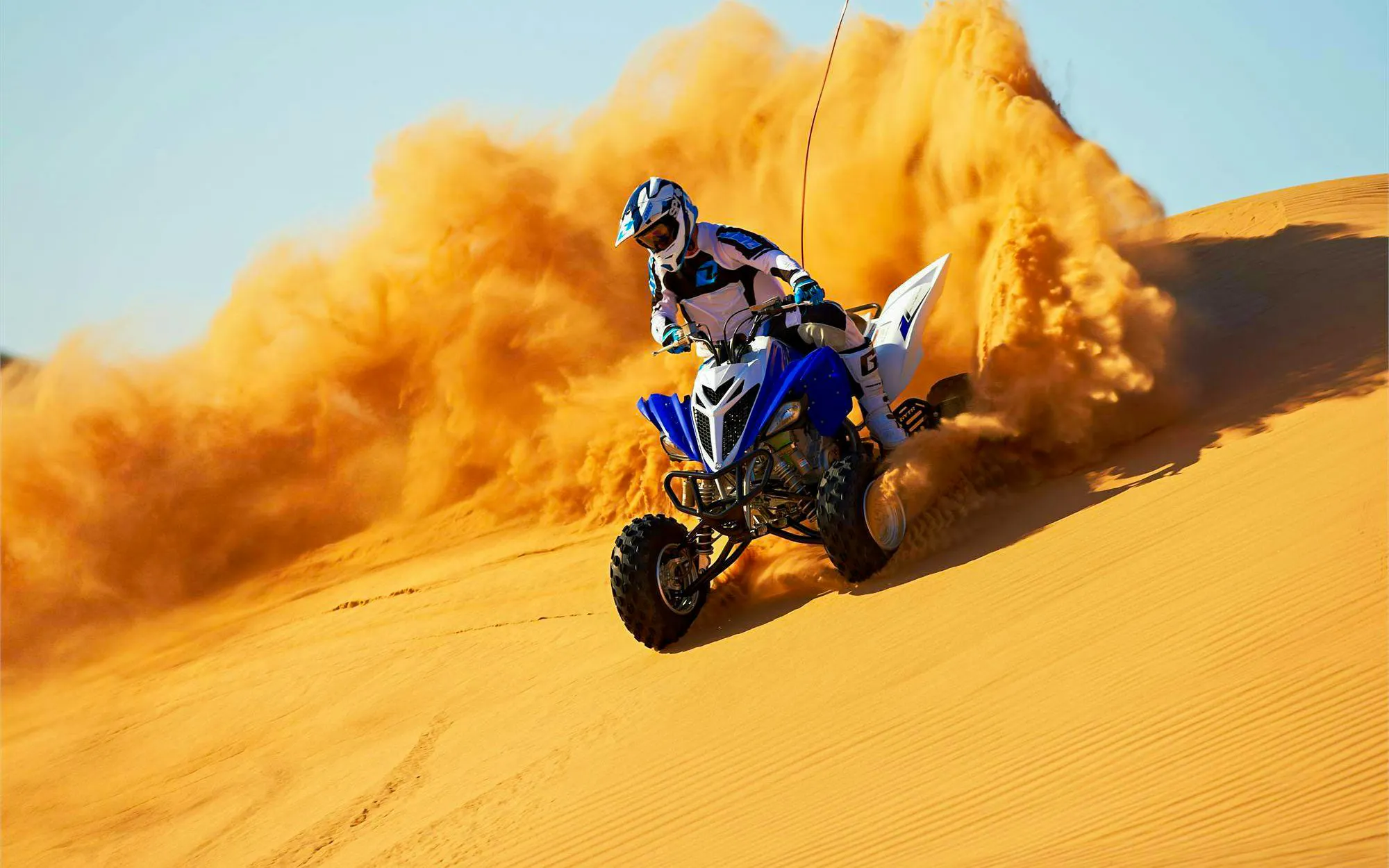 Quad biking on sand dunes during Dubai Desert Safari.