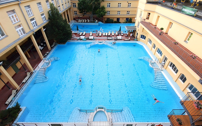 Lukacs Thermal Bath outdoor pool with swimmers in Budapest.