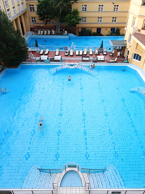 Lukacs Thermal Bath outdoor pool with swimmers in Budapest.
