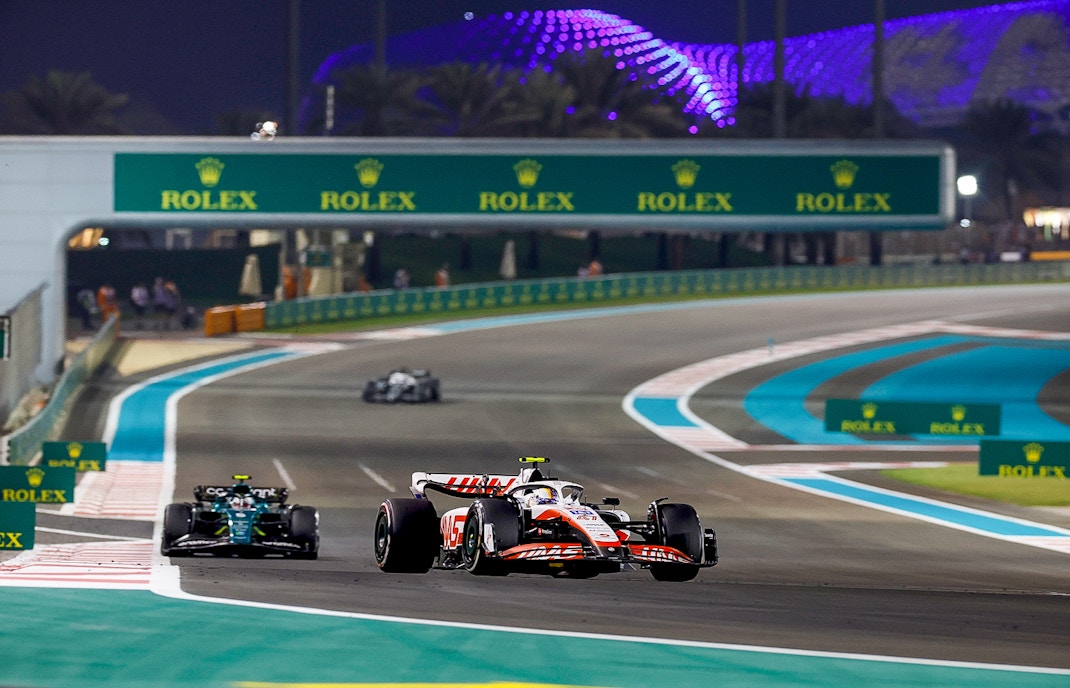 Formula 1 cars racing on Yas Marina Circuit, Abu Dhabi Grand Prix.