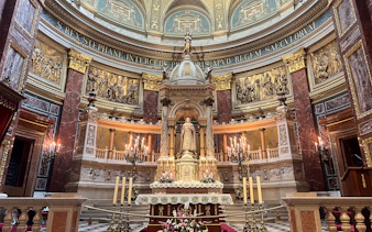 St. Stephen's Basilica interior with ornate altar and statue, Budapest.