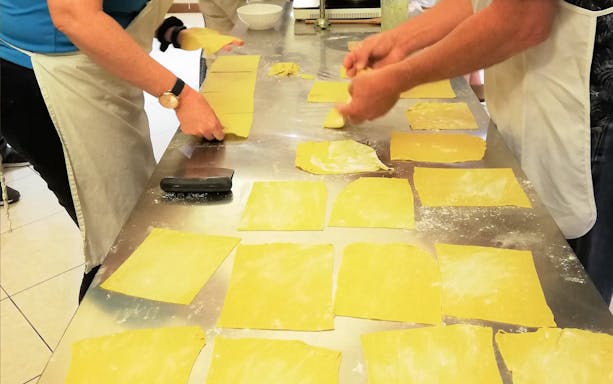 Participants making pasta in a Florence cooking class.