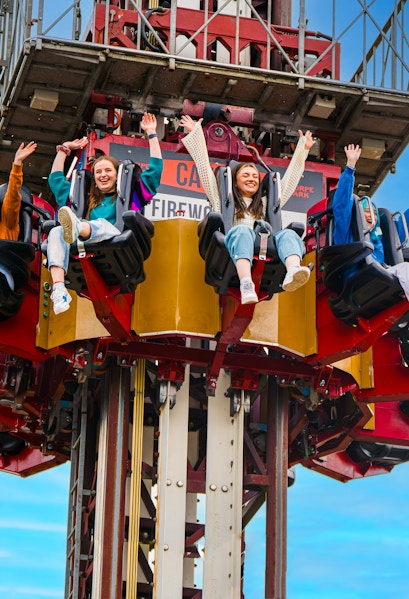 Visitors enjoying a drop tower ride at Thorpe Park.