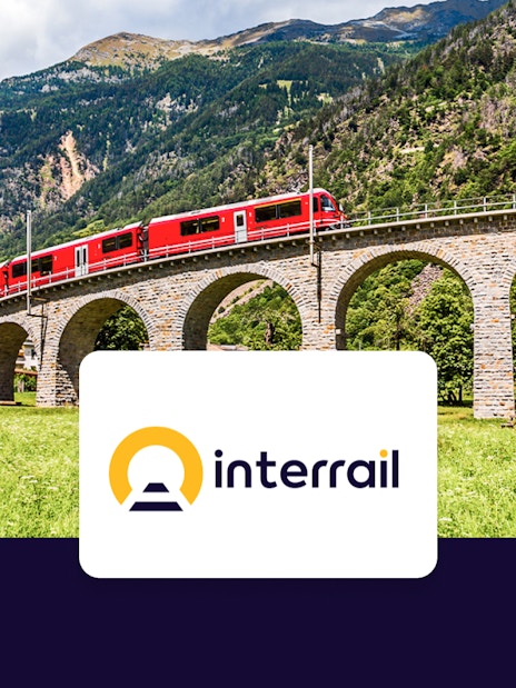 Bernina Express crossing a stone viaduct in the Swiss Alps.