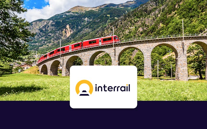 Bernina Express crossing a stone viaduct in the Swiss Alps.