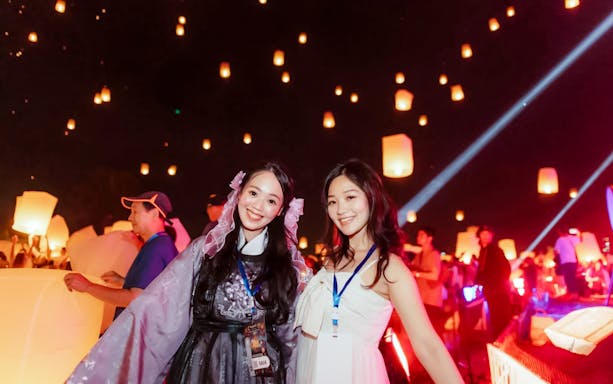 Group releasing lanterns at Yipeng Lantern Festival, Chiang Mai, Thailand.