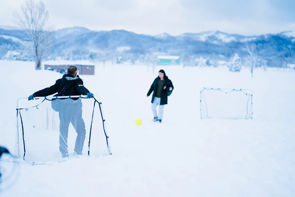People playing soccer in the snow during Sapporo to Bibai Snow Land tour, Hokkaido.
