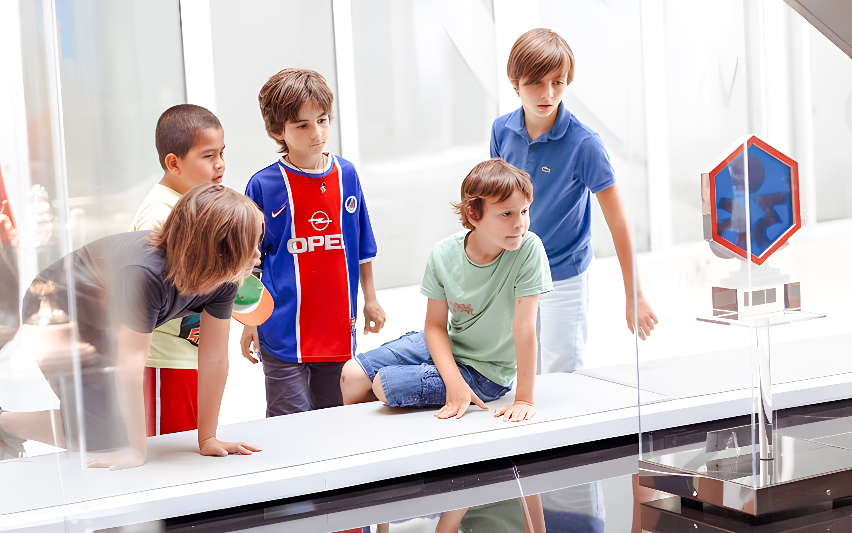 Children observing a display at PSG Stadium, Paris, France.