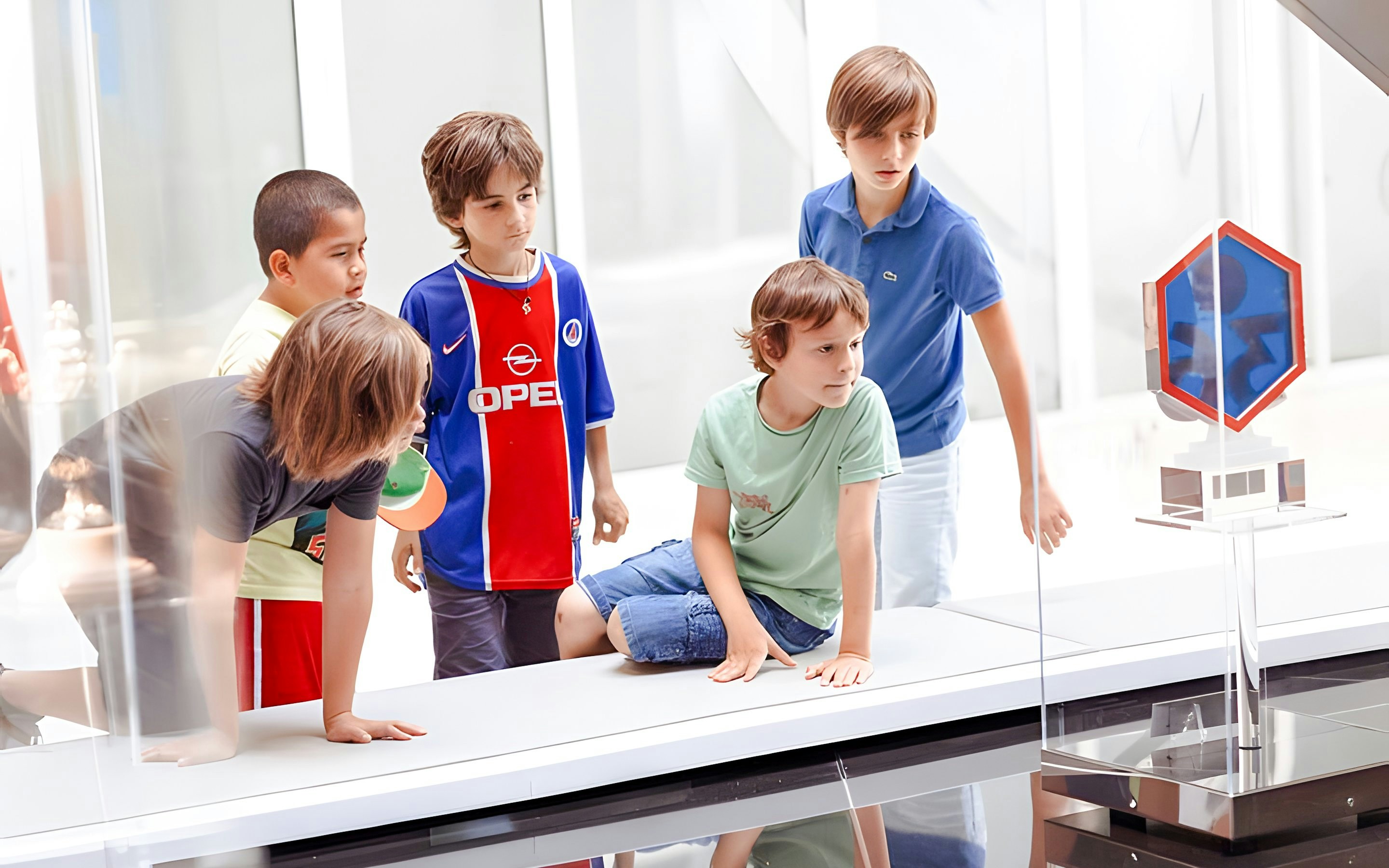 Children observing a display at PSG Stadium, Paris, France.