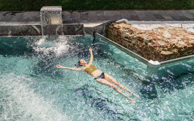 Visitor relaxing in the pool at QC Terme Milano Resort & Spa.
