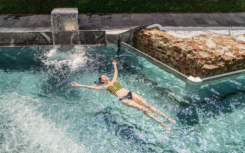 Visitor relaxing in the pool at QC Terme Milano Resort & Spa.