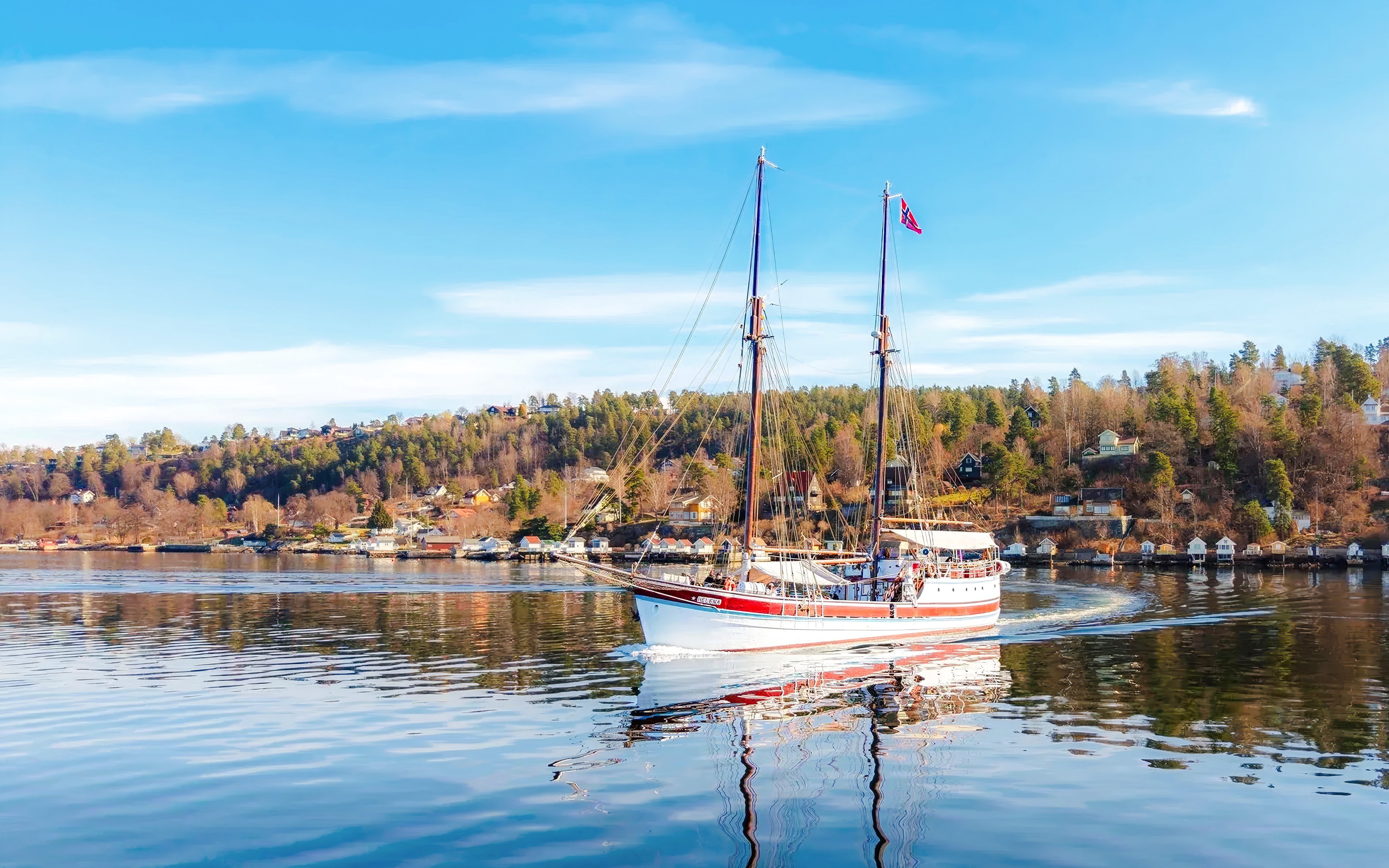 Sailing ship on Oslo fjord sightseeing cruise with coastal landscape.