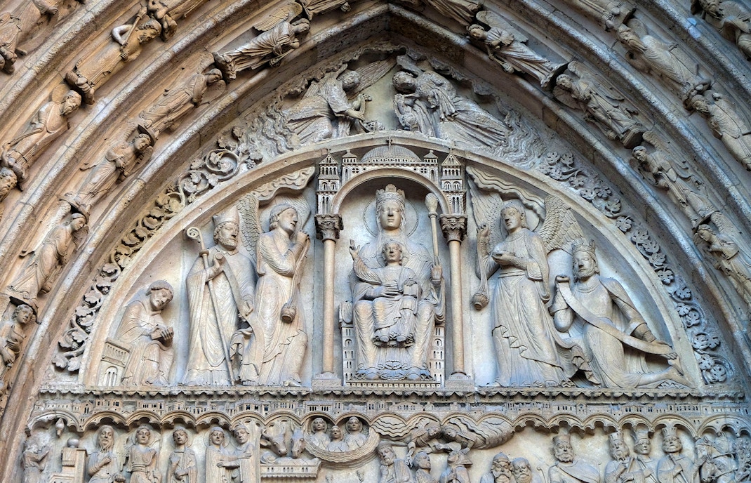 Chapel of St. Anne interior, Notre Dame, Paris, showcasing ornate altar and stained glass windows.