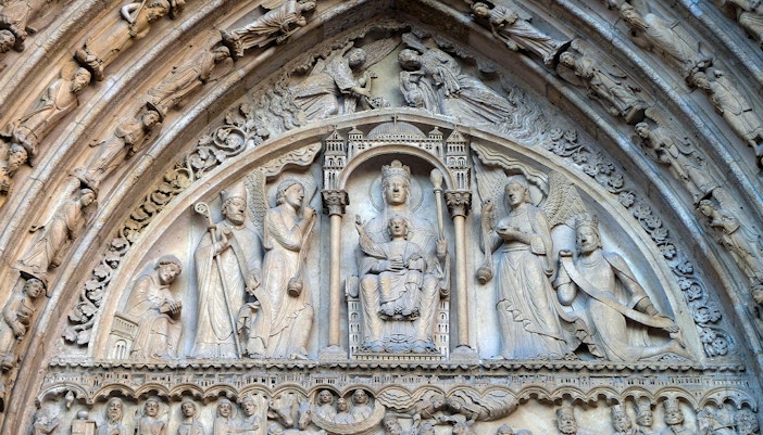 Chapel of St. Anne interior, Notre Dame, Paris, showcasing ornate altar and stained glass windows.