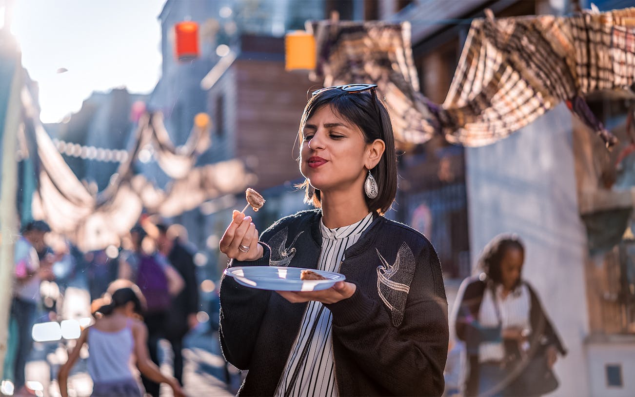 Eating escargot on a street in Montmartre, Paris during a food tour.
