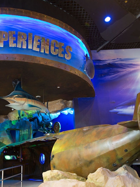 Dubai Aquarium entrance with marine life displays and submarine propeller exhibit.