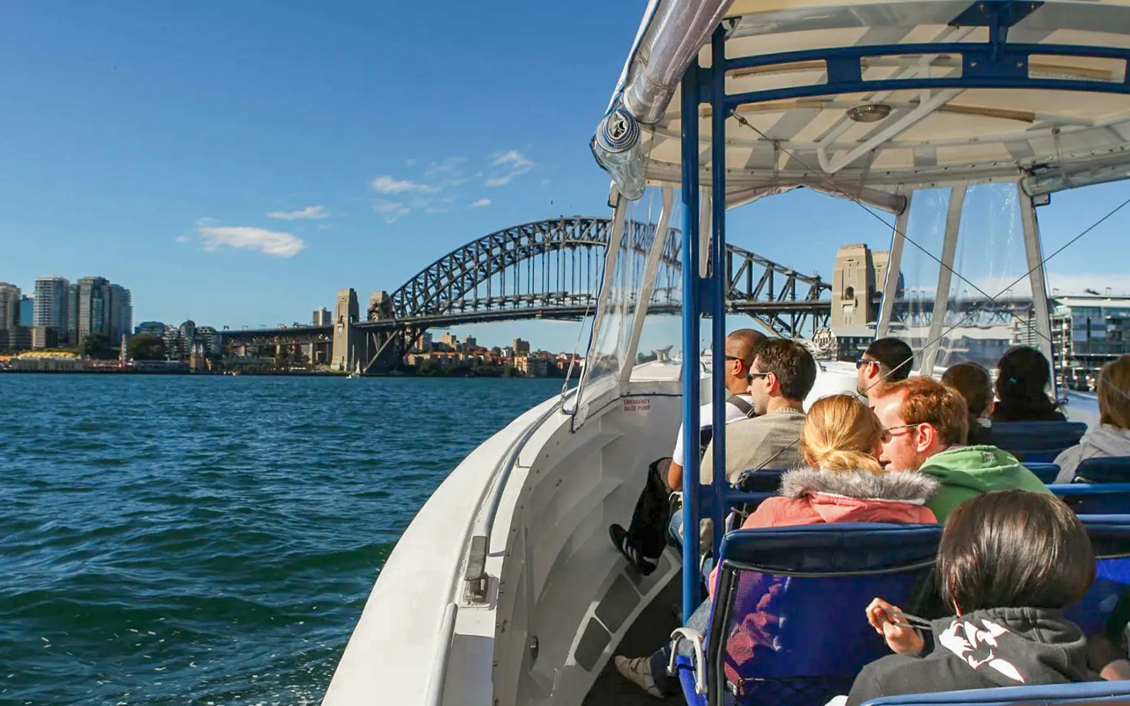 Group on catamaran whale watching cruise in Sydney Harbour with Harbour Bridge in background