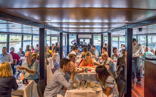 Dining guests on the Spirit of Melbourne Cruising Restaurant enjoying a meal.