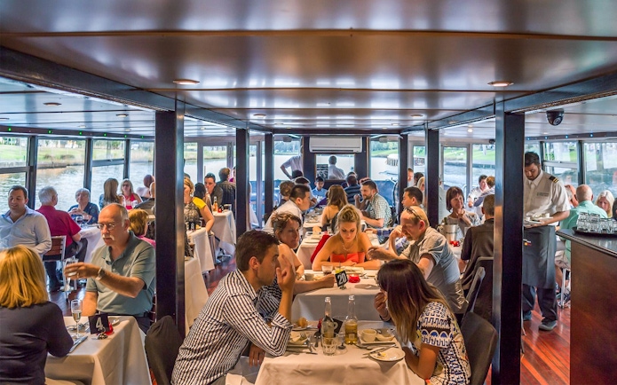Dining guests on the Spirit of Melbourne Cruising Restaurant enjoying a meal.