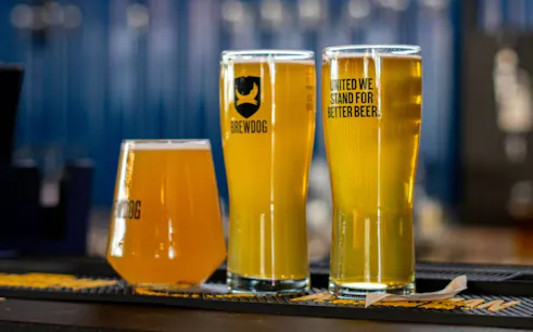 Beer flight with three glasses at BrewDog Dubai.