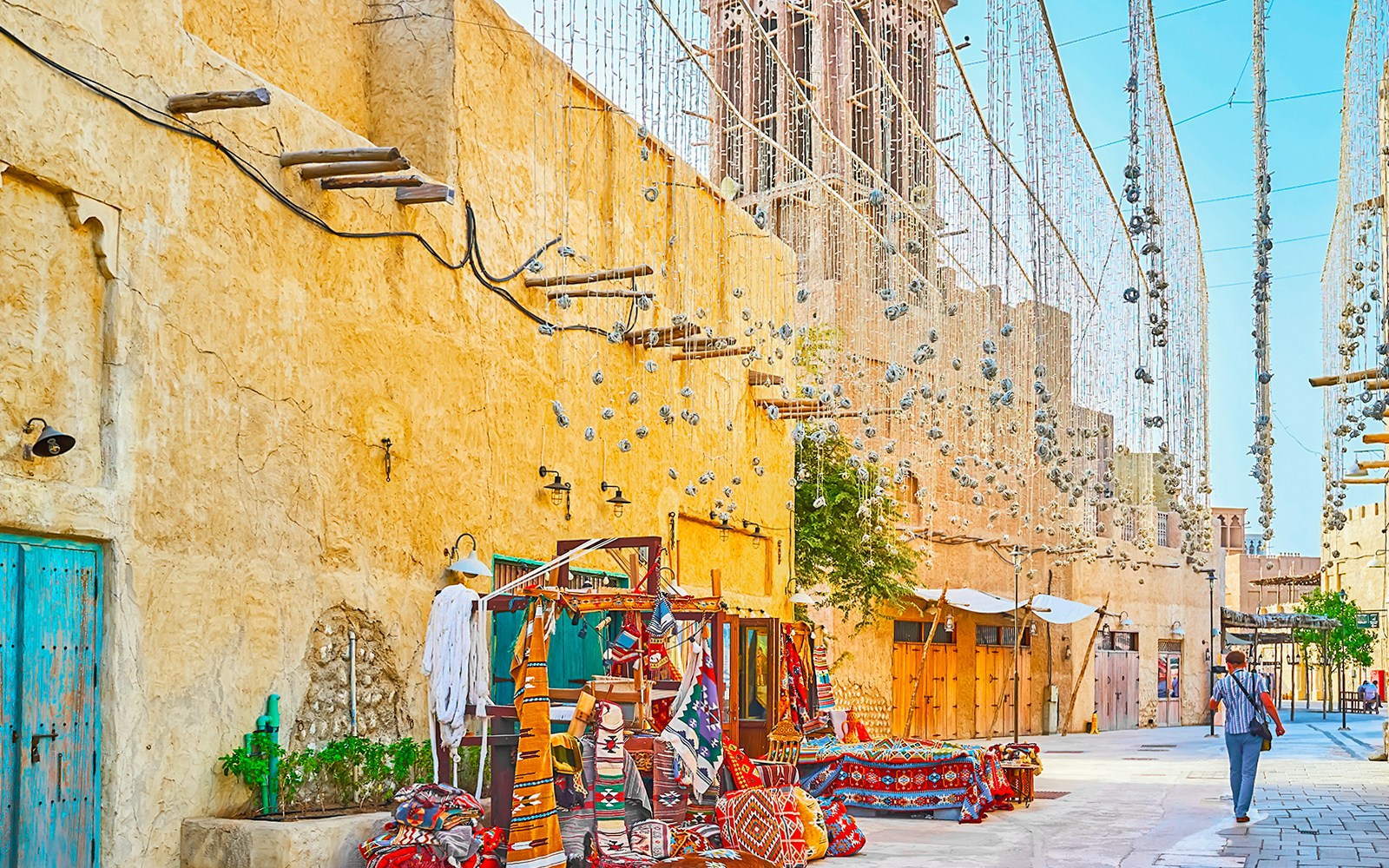 Al Fahidi Historical Neighbourhood market with traditional textiles and wind towers.