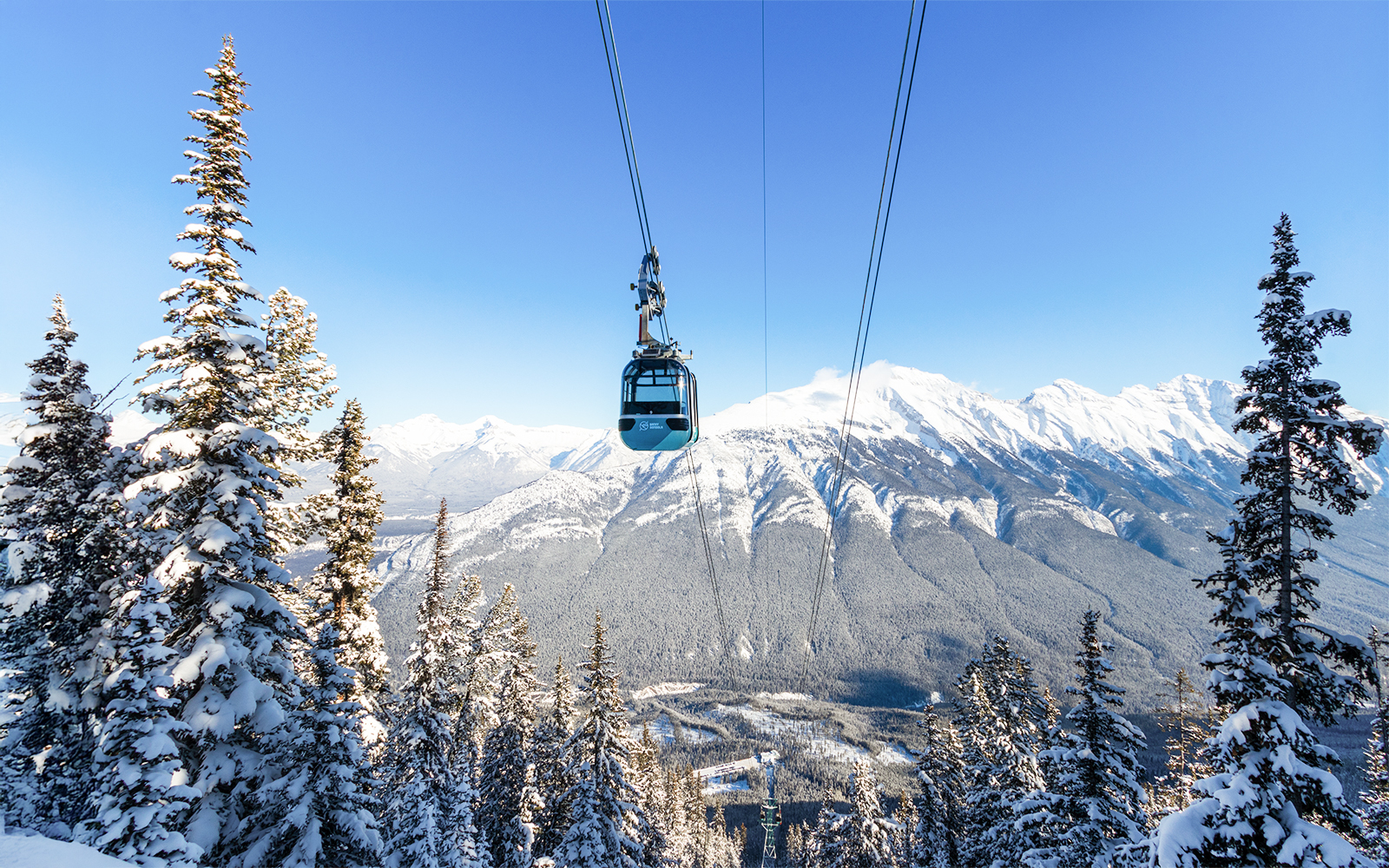 Banff Sightseeing Gondola over snow-covered Sulphur Mountains in Banff National Park.