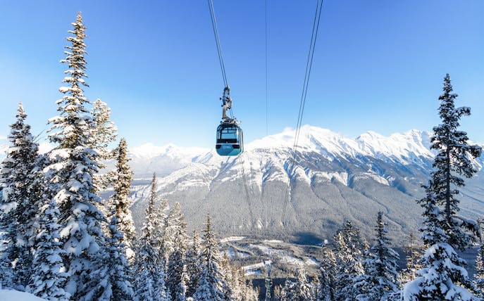 Banff Sightseeing Gondola over snow-covered Sulphur Mountains in Banff National Park.