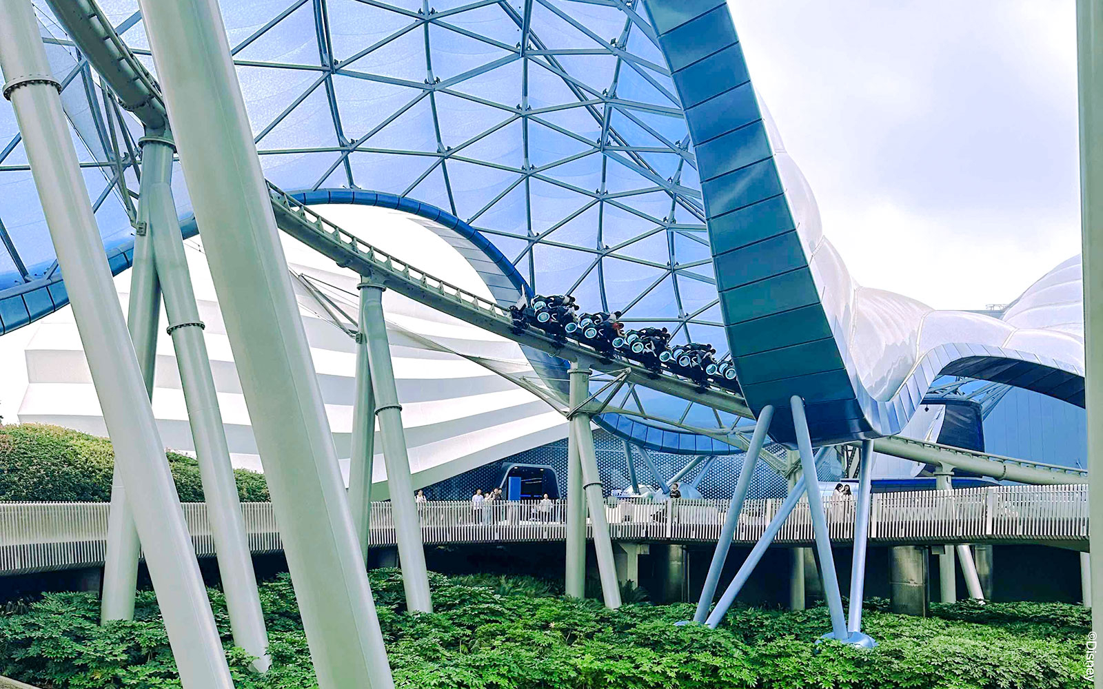 TRON Lightcycle Power Run roller coaster under futuristic canopy.
