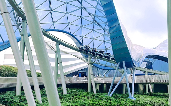 TRON Lightcycle Power Run roller coaster under futuristic canopy.
