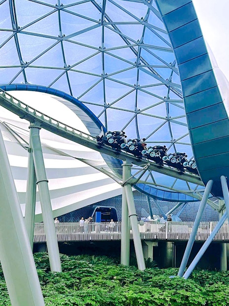 TRON Lightcycle Power Run roller coaster under futuristic canopy.