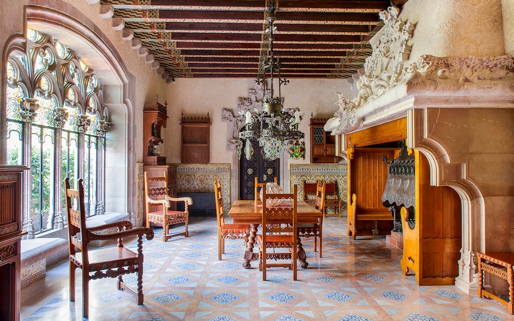 Casa Amatller dining room with ornate wooden furniture and stained glass windows.