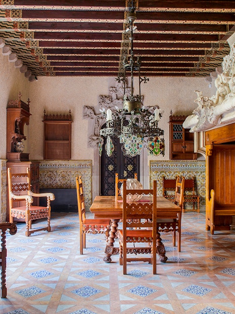 Casa Amatller dining room with ornate wooden furniture and stained glass windows.