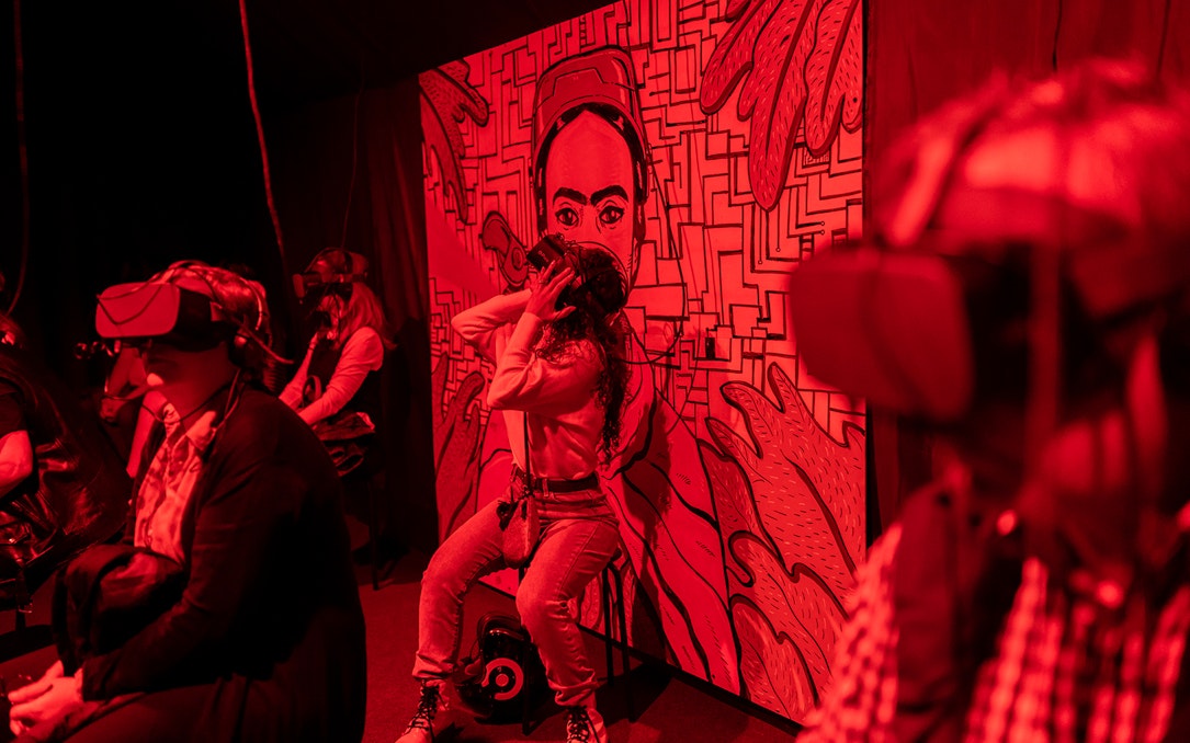 Visitors experiencing Frida Kahlo immersive biography with VR headsets.