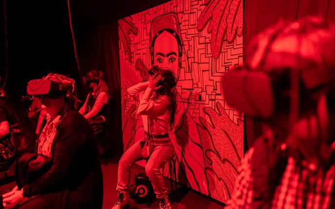 Visitors experiencing Frida Kahlo immersive biography with VR headsets.