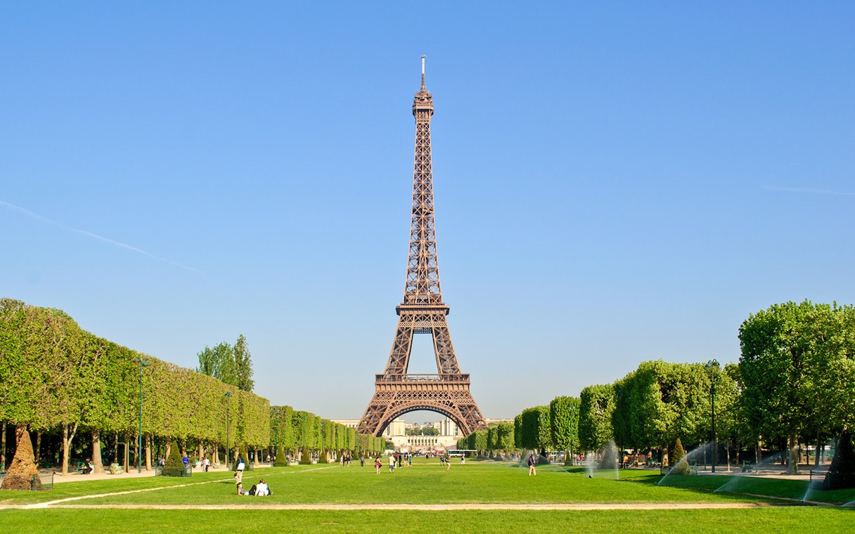 Eiffel Tower with surrounding gardens in Paris, viewed from Champ de Mars.