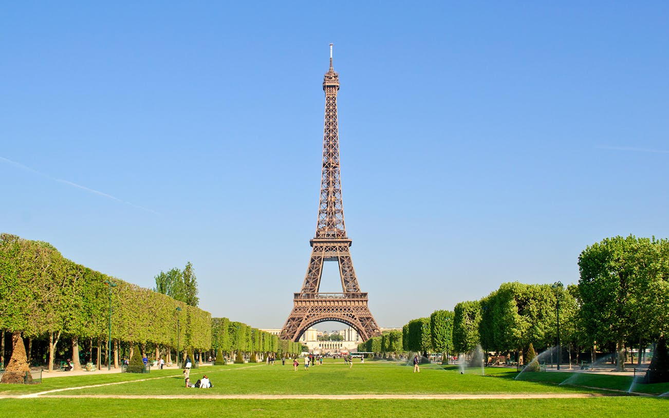 Eiffel Tower with surrounding gardens in Paris, viewed from Champ de Mars.