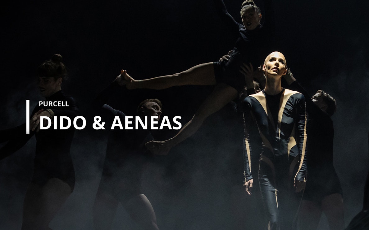 Performers in a dramatic scene from Purcell's opera "Dido & Aeneas" on stage.