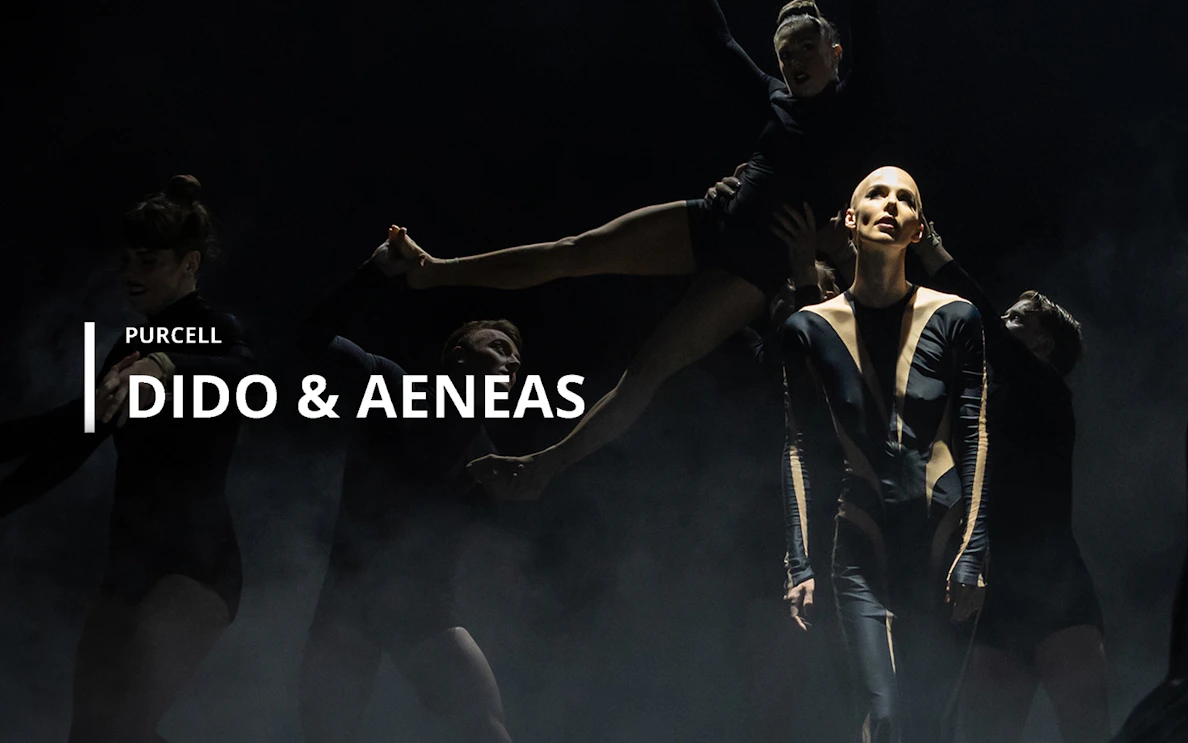 Performers in a dramatic scene from Purcell's opera "Dido & Aeneas" on stage.