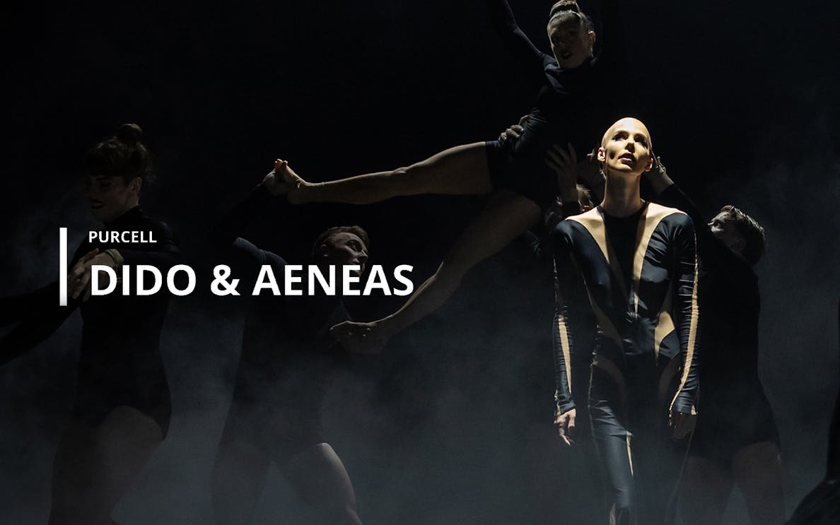 Performers in a dramatic scene from Purcell's opera "Dido & Aeneas" on stage.