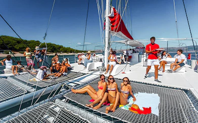 Guests relaxing on a catamaran cruise with barbeque in Santorini.