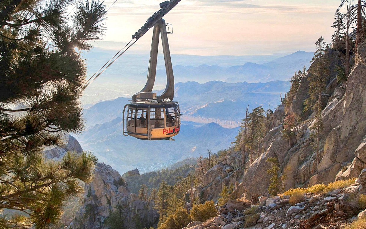 Aerial tramway ascending over rocky landscape in Palm Springs.