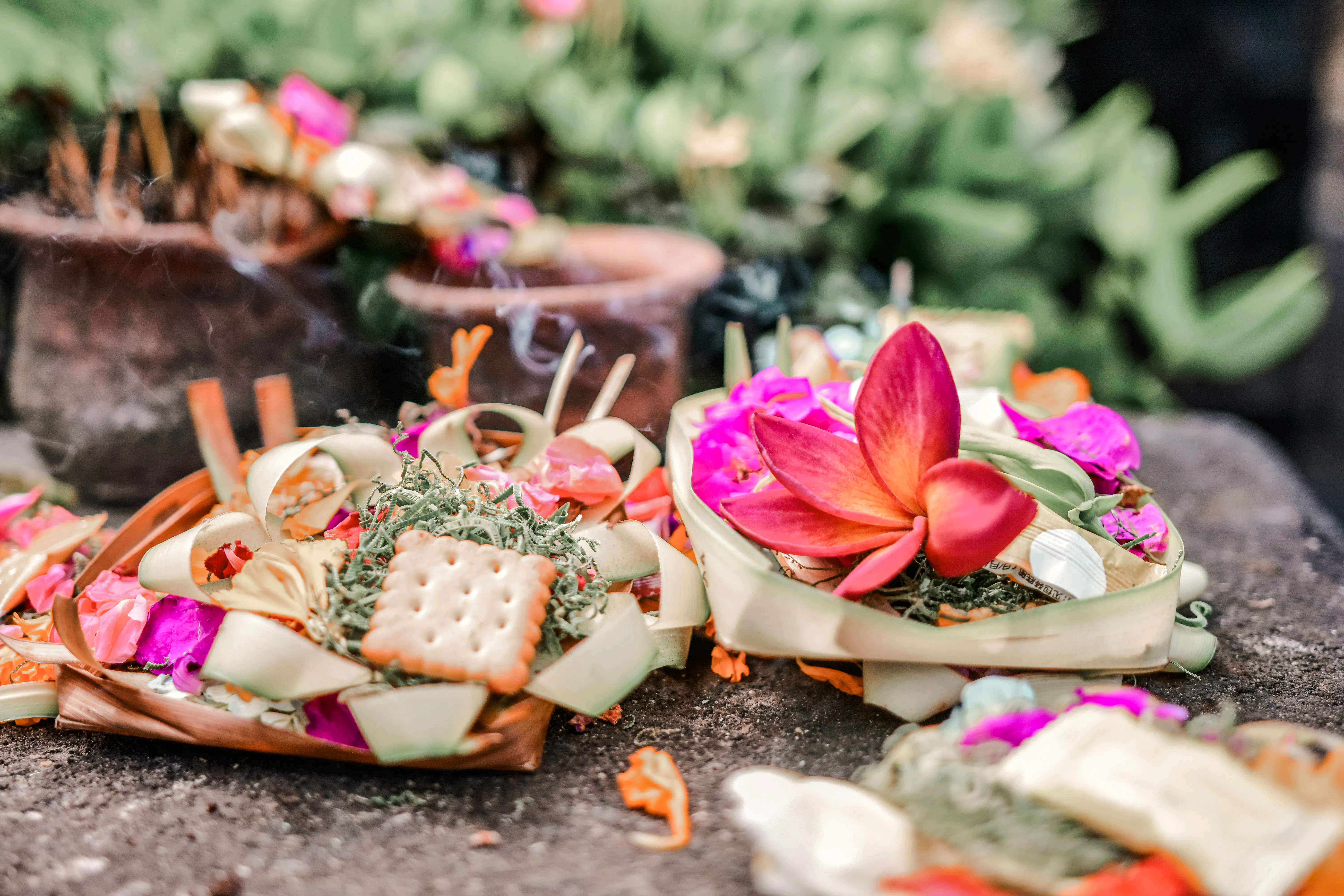 Balinese offerings with flowers and incense at Tirta Empul Temple, Bali.