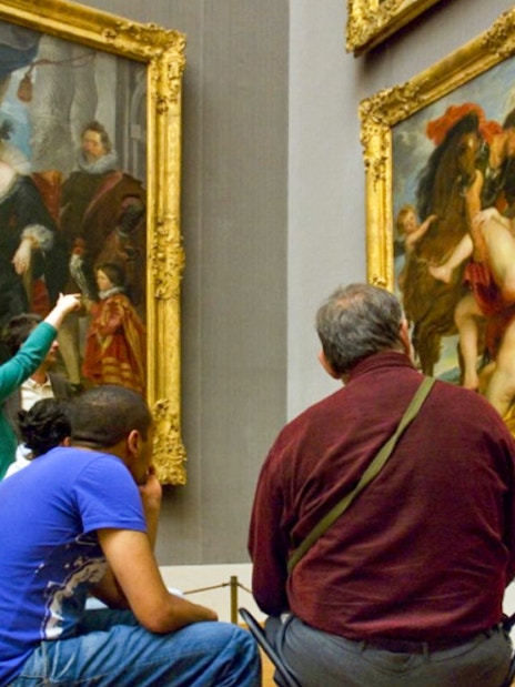 Visitors viewing classic paintings in a Munich art museum with the Munich City Pass.