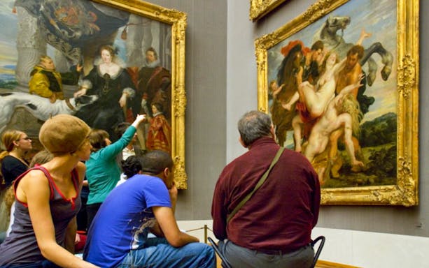 Visitors viewing classic paintings in a Munich art museum with the Munich City Pass.